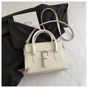 Close-up of cream PU leather handbag featuring silver metal buckle and adjustable strap