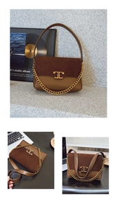 Macro view of brown patchwork leather shoulder bag with gold chain and metal logo