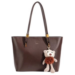 Large dark brown vintage tote bag with gold hardware and a cute knit bear charm