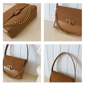 Detail view of brown leather and suede crossbody bag with vintage gold metal logo buckle