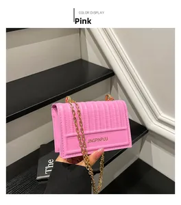 Pink quilted crossbody bag with golden chain strap and textured synthetic leather detail