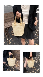 Detail of a beige woven straw tote bag featuring high-capacity design for autumn travel
