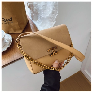 Detail of khaki suede shoulder bag with gold T-clasp and chunky metallic chain strap