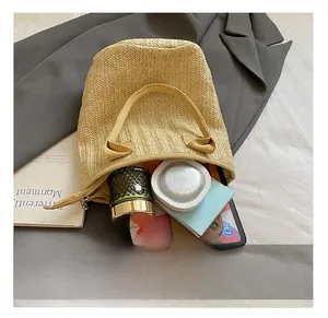 Interior view of beige woven tote bag showing spacious capacity for phone and cosmetics