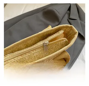 Close-up of metal zipper closure on a woven tote bag with a soft fabric inner lining
