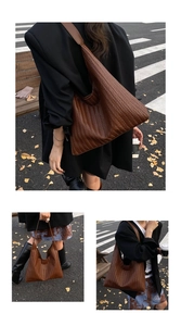 Detail of dark brown woven tote bag with herringbone pattern and wide shoulder strap