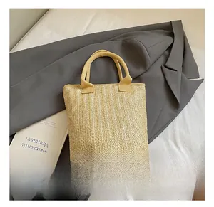 Top-down view of cream woven bucket bag on suit fabric with aesthetic minimalist book