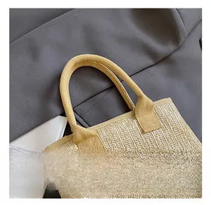 Detail of V-shaped woven beige straw bucket bag with circular handle and summer vibes