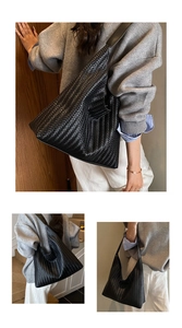 Detail shot of black woven hobo bag showing the intricate herringbone texture and large capacity