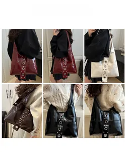 Detail view of stylish faux leather underarm bags with metallic grommet accent in four colors
