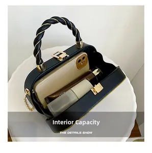 Internal capacity of the black crossbody bag showing space for phone and lipstick