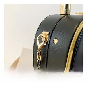 Close-up of black leather bag with premium gold metal hardware and chain detail