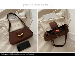 Detail view of large brown suede hobo bag with gold metal buckle and spacious main pocket