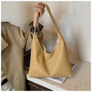 Detail of light brown woven leather Hobo bag with wide strap and V-pattern texture