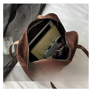 Spacious interior of brown matte tote bag showing storage for tablet, books and cosmetics