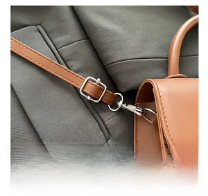 Detail of silver hardware clasp and adjustable strap buckle on a vintage brown leather bag