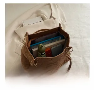 Internal view of brown quilted tote bag showing large capacity for tablet and daily items