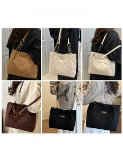 Quilted tote bag detail showcasing classic diamond stitching and metal chain strap in six colors