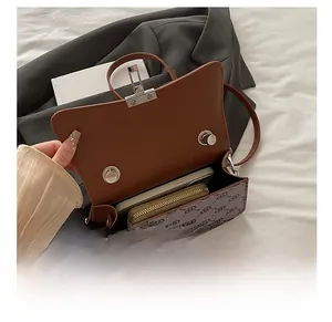 Detailed interior of vintage crossbody bag showing phone and wallet storage capacity