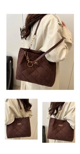 Close-up of dark coffee quilted tote bag featuring gold logo detail and chain shoulder strap