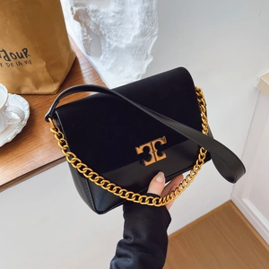 Minimalist black leather crossbody bag with gold chain and metal hardware detail