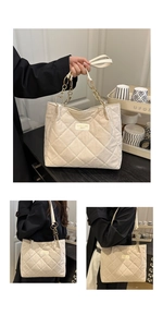 Close-up of beige quilted tote bag showing metal chain strap and fine suede texture