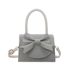 Sparkling silver glitter mini square bag with large bow and adjustable shoulder strap
