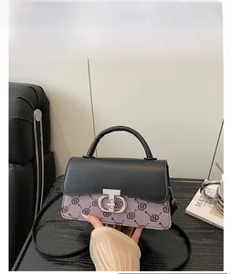 Detail of vintage square bag with black-purple monogram leather and silver metal clasp