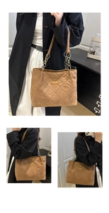 Detail of camel quilted tote bag featuring classic diamond stitching and gold chain straps