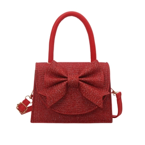 Red sequin evening clutch bag with a large bow and adjustable shoulder strap for gala party