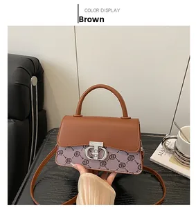 Detail of brown floral print crossbody bag featuring metal turn-lock and adjustable strap