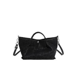 Black leopard print tote bag with adjustable shoulder strap and silver hardware