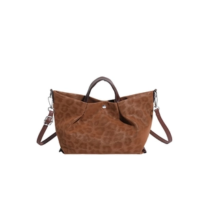 Brown leopard print suede tote bag with leather handles and adjustable shoulder strap