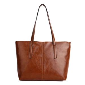 Brown vintage oil wax leather tote bag with vertical stitching and long shoulder straps