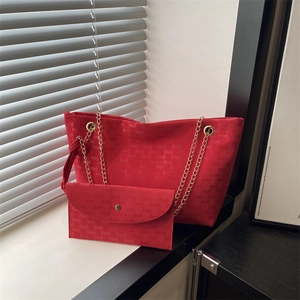 Red canvas tote bag with chain strap and matching clutch featuring elegant monogram pattern
