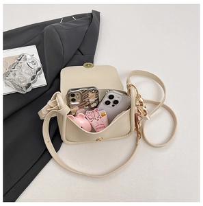 Internal view of beige crossbody bag showing phone storage capacity and silk scarf detail