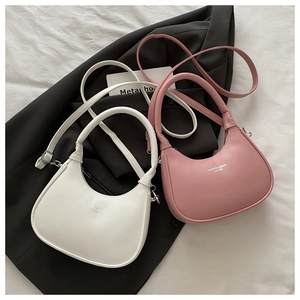 Flat lay showing white and pink crescent moon hobo bags on a minimalist background