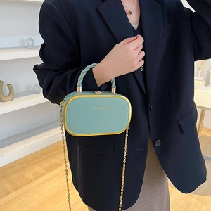Elegant light green box handbag with gold frame and twisted handle for women