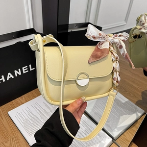 Pale yellow flap shoulder bag with metal buckle and decorative printed silk scarf