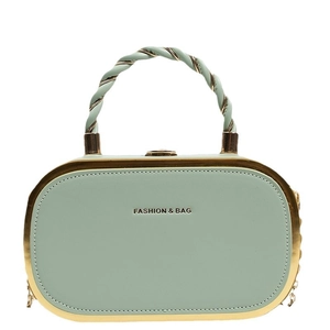 Pale green oval hard shell handbag with twisted handle and golden metal chain strap