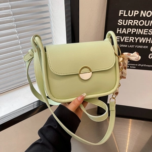 Avocado green leather shoulder bag with gold clasp and polka dot scarf detail
