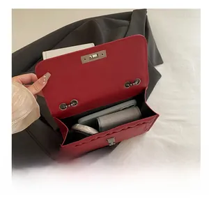 Inside view of red quilted crossbody bag showing storage space for phone and makeup
