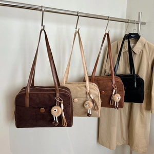 Vintage suede Boston bags in four colors with plush charms and minimalist button detail
