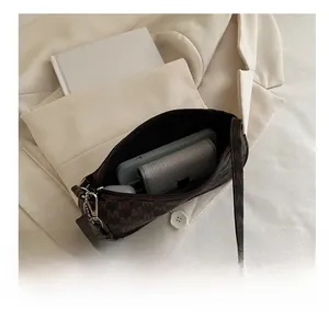 Macro shot showing internal capacity of vintage monogram crescent bag with phone and wallet
