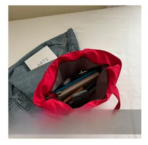 Top view of large red nylon tote bag interior showing spacious capacity for daily items