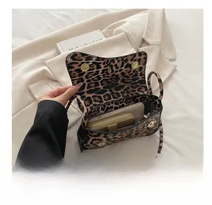 Interior view showing the large capacity of the leopard print shoulder bag and magnetic clasp
