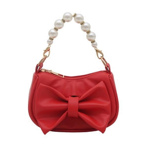 Stylish red handbag with a large bow, faux leather finish, and elegant pearl handle