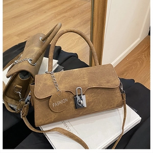Detailed view of brown retro crossbody bag with silver rotary lock and fashion tag