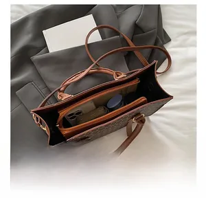 Detailed interior view of a large brown tote bag showing ample space for daily essentials