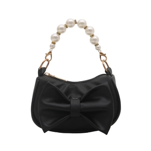 Elegant black lipstick bag featuring a large bow and premium white pearl handle detail